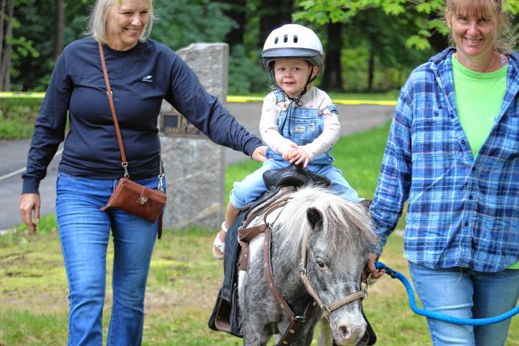Sutton Salo, 2, of Rindge, gets a ride on Cookie at the pony rides.