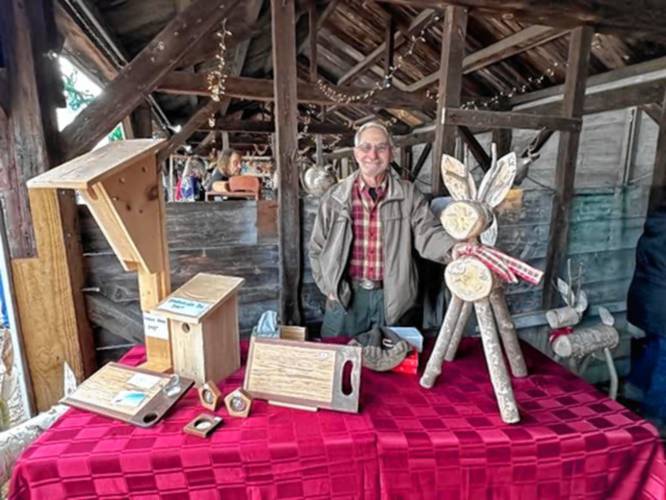 Steve Berry with his Woodworks by Steve birchwood reindeer, charcuterie boards and bluebird houses.